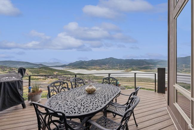 Deck featuring a mountain view, a grill, and outdoor dining area | Image 60
