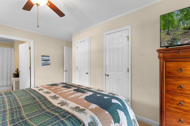 Bedroom with ornamental molding, a ceiling fan, and carpet | Image 17