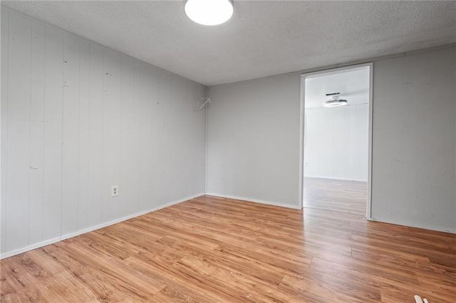 Unfurnished room featuring light wood-style flooring and a textured ceiling | Image 18