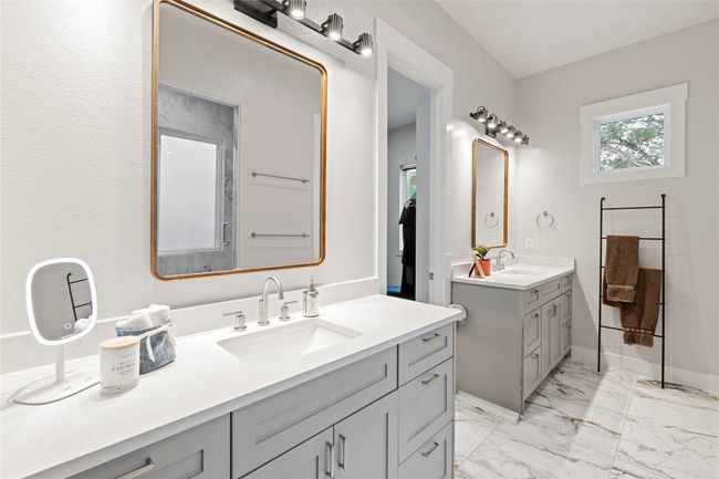 Full bathroom featuring two vanities, marble finish flooring, and baseboards | Image 16