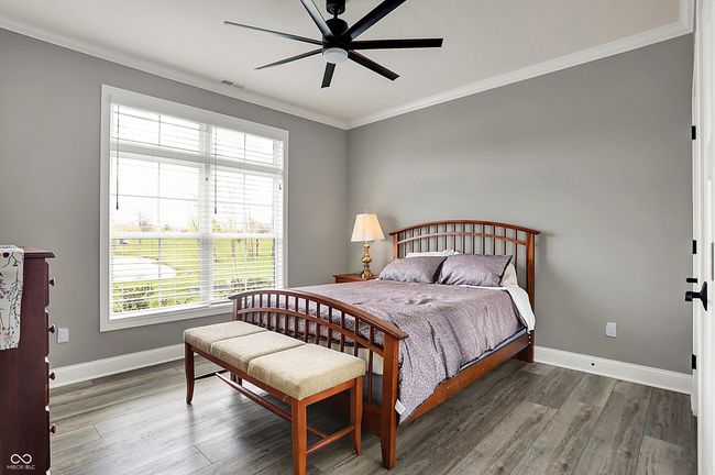 bedroom featuring visible vents, ornamental molding, baseboards, and multiple windows | Image 32