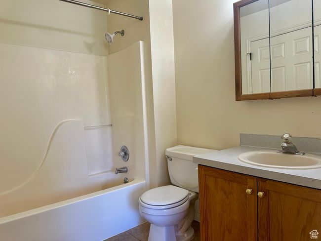 Full bath featuring vanity, tub / shower combination, and tile patterned floors | Image 22