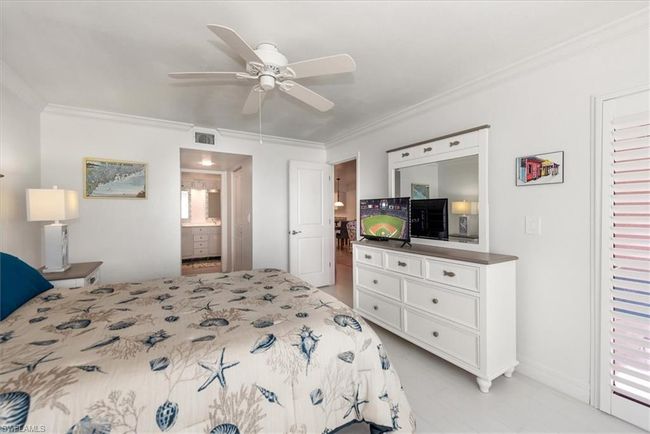 Bedroom featuring crown molding, ensuite bathroom, and ceiling fan | Image 18