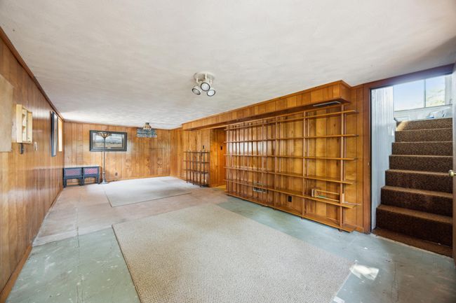 Lower level with family room. Stairs to the right lead to the porch that has patio doors leading to the lake. | Image 23