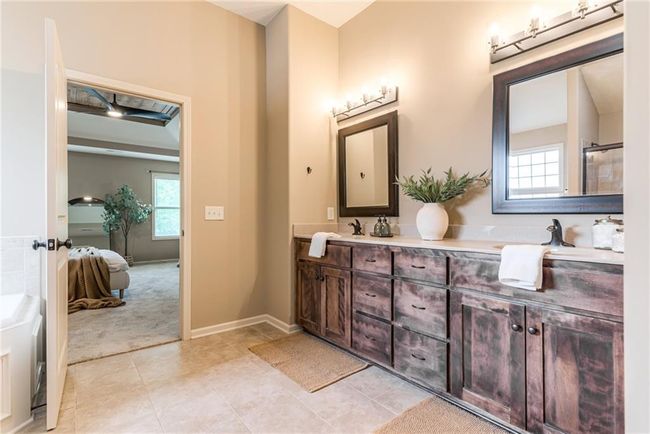 Ensuite bathroom with double vanity and tile patterned flooring | Image 28