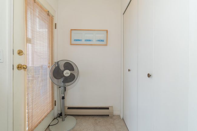 Entryway featuring a baseboard heating unit and tile patterned floors | Image 16