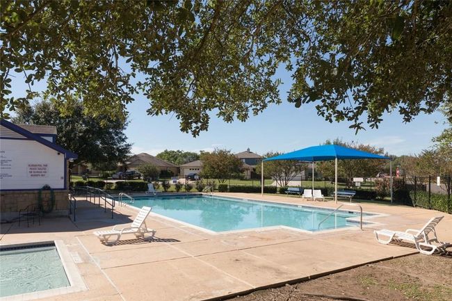 Community pool featuring fence and a patio area | Image 23