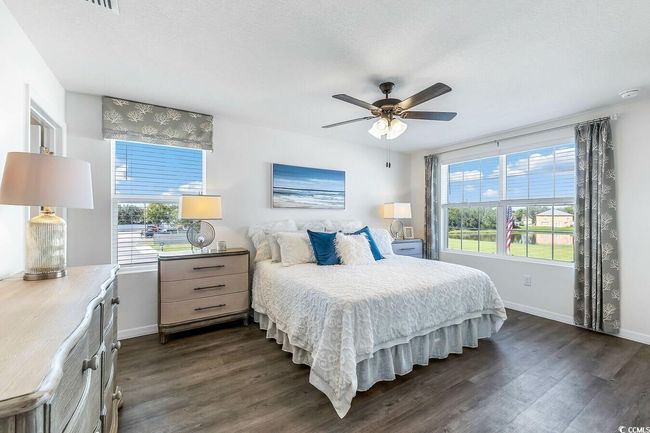 Bedroom with dark wood-style floors and a ceiling fan | Image 17