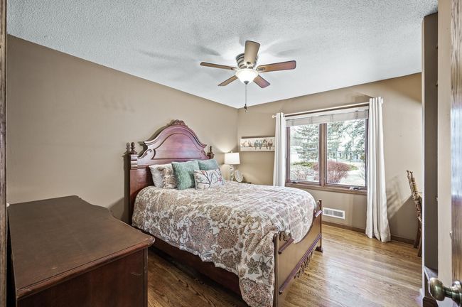 Main floor bedroom number two - Hardwood floors and beautiful front yard view - | Image 30