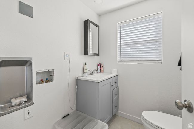 Half bath with vanity, toilet, tile patterned flooring, and baseboards | Image 17