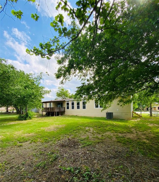 View of yard featuring a wooden deck | Image 34