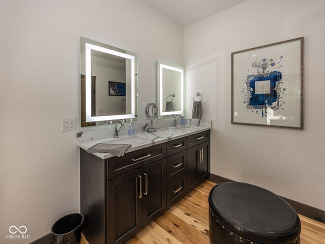 full bath with wood finished floors, double vanity, and baseboards | Image 21