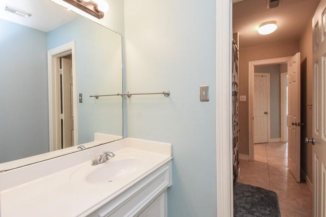 This 8' x 5' bathroom is also complete with a shared shower/tub combo. The 2nd sink and vanity area also has plenty of cabinet space and is perfect for children to have their own space. | Image 23