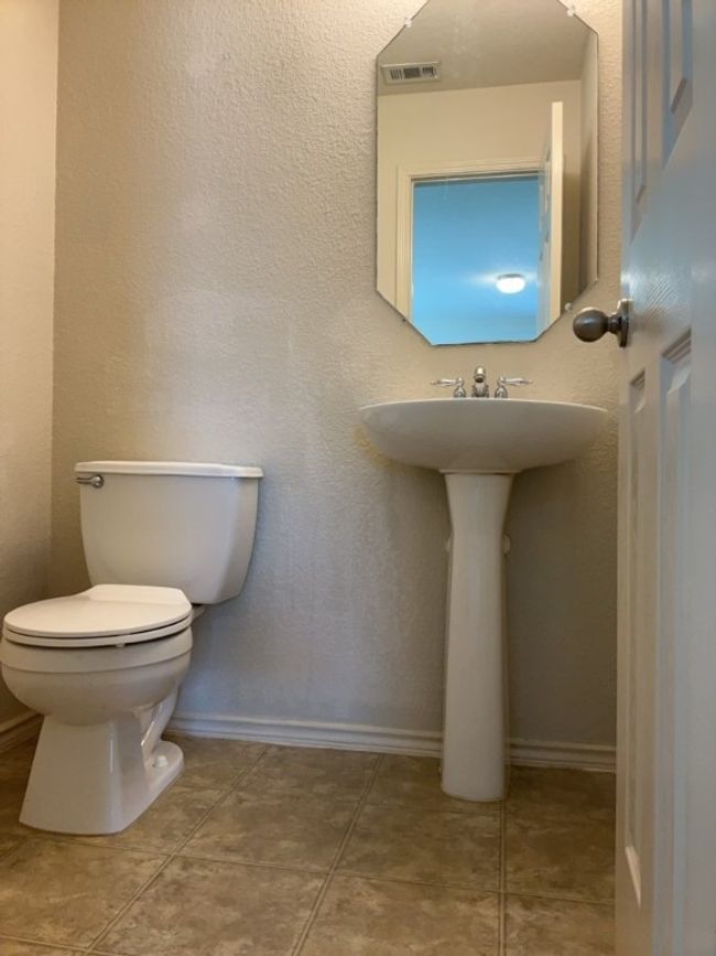 Half bathroom featuring toilet and tile patterned floors | Image 21