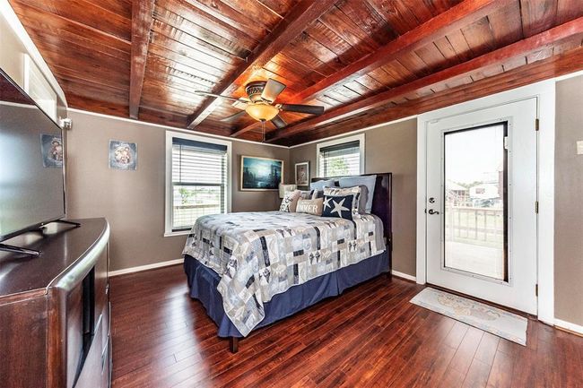 Primary bedroom with it's own door to the deck, sneak out to fish or to catch some views | Image 21