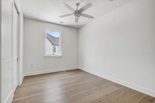 Empty room with baseboards, light wood-style floors, and ceiling fan | Image 23
