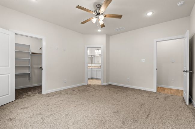 Unfurnished bedroom featuring carpet floors, baseboards, a spacious closet, recessed lighting, and connected bathroom | Image 19