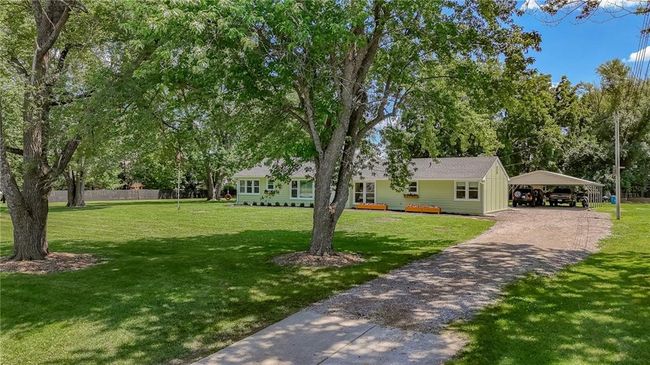 View of green lawn featuring a detached carport and driveway | Image 54