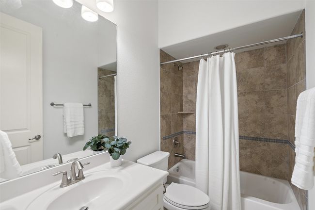 Full bathroom downstairs with shower / bath combo with shower curtain and vanity | Image 13