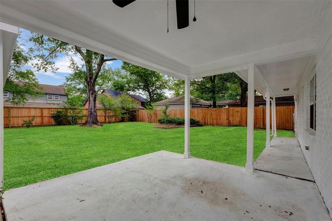 Large covered patio with ceiling fan. | Image 36