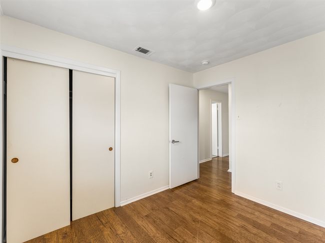 Unfurnished bedroom featuring hardwood / wood-style floors and a closet | Image 20