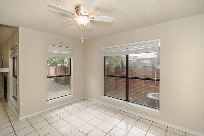 Spare room featuring ceiling fan, light tile patterned floors, and a textured ceiling | Image 6