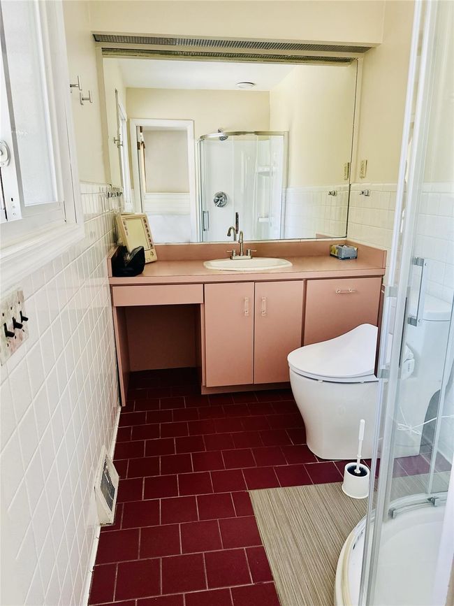 Bathroom with toilet, vanity, tile walls, and walk in shower | Image 21