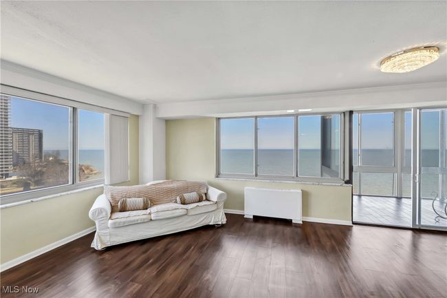 Living room with baseboards, radiator, and wood finished floors | Image 5