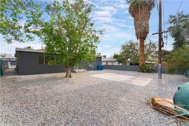 View of yard with fence and a patio area | Image 34