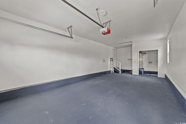 Garage with water heater and a garage door opener | Image 39