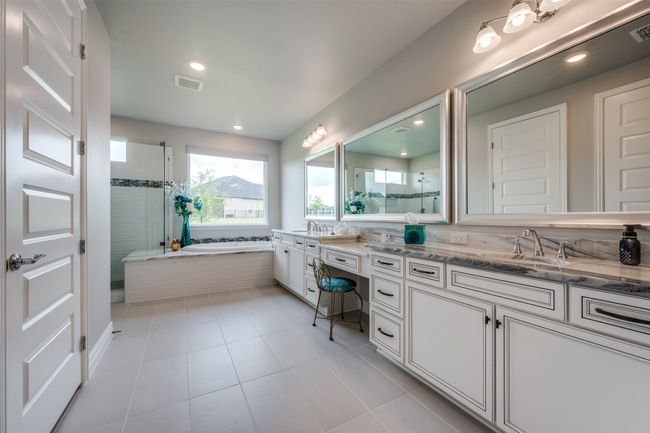 Primary Bathroom with vanity, separate shower and tub, Dolomite countertops and tile flooring | Image 13
