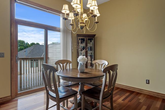 Convenient walkout access to your private deck delivers a great extension of your casual dining. Enjoy overlooking green space and active wildlife that often make a friendly appearance in the community! | Image 10