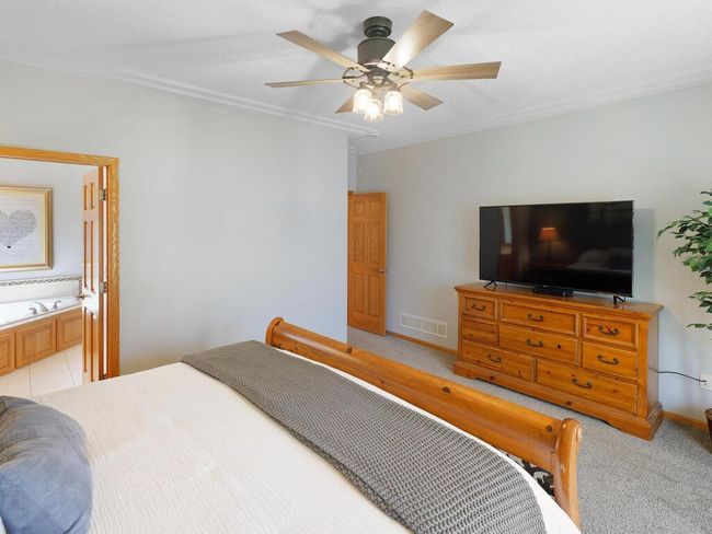 Primary Bedroo with ceiling fan and racetrack ceilings - 25259 Galaxy Ave Wyoming MN 55092 USA-048-092-049-MLS_Size.jpg | Image 25