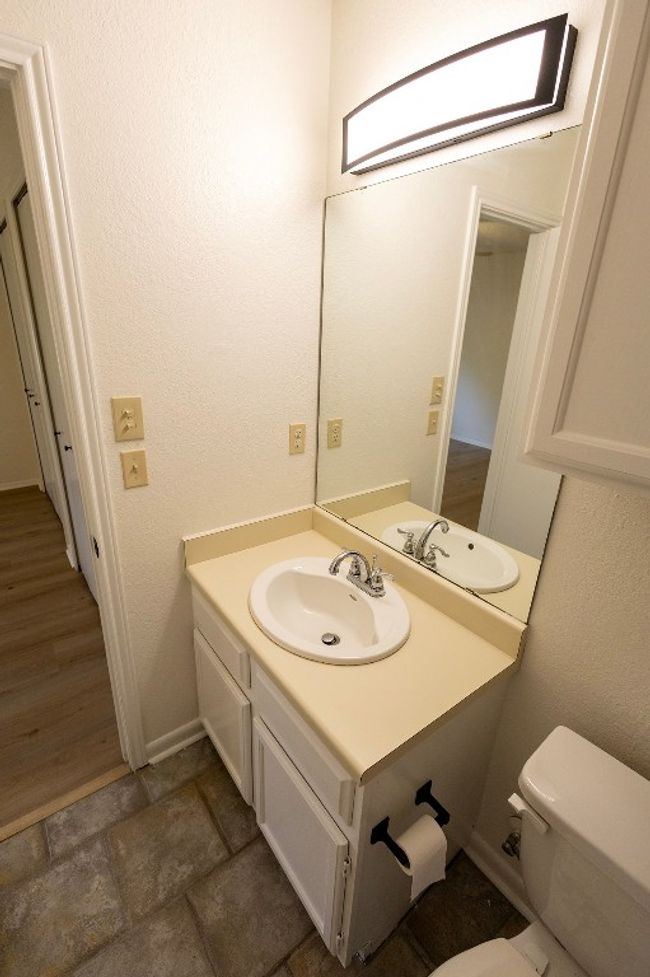 Bathroom with vanity, toilet, and baseboards | Image 25