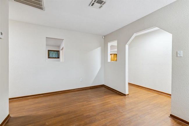 Formal living room looking in from large windows | Image 6