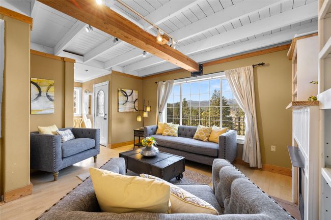 Living area with beamed ceiling, wood ceiling, light wood finished floors | Image 9