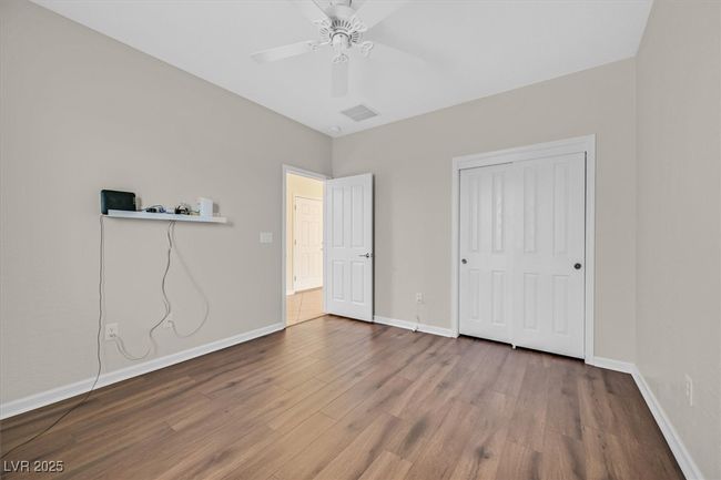 bedroom featuring baseboards, ceiling fan, LVP flooring | Image 23