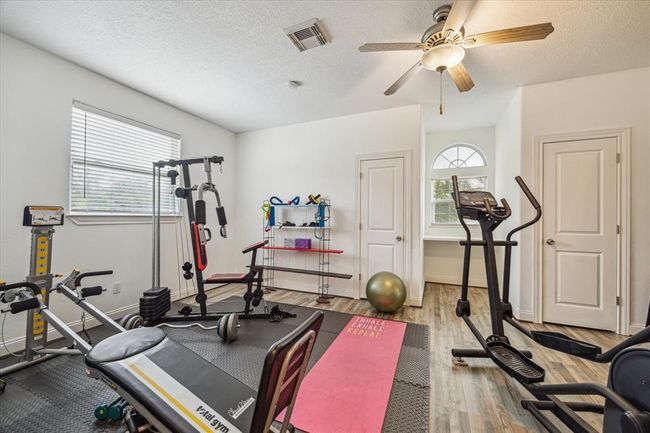 New laminate wood floors put in 2023. This bedroom with two walk-in closets is currently being used as a gym. | Image 24