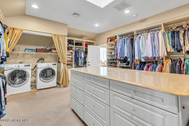 Walk-in Closet with Dressing Island and laundry | Image 60