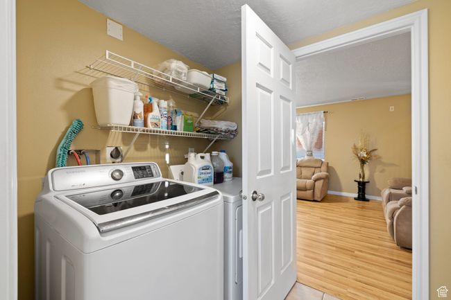 Laundry room with washer and dryer, hardwood / wood-style floors, and a textured ceiling | Image 34