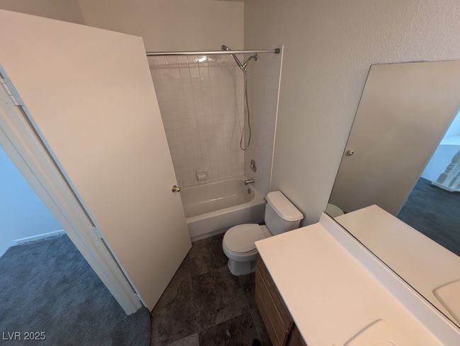 Bathroom featuring toilet, shower / washtub combination, and vanity | Image 14