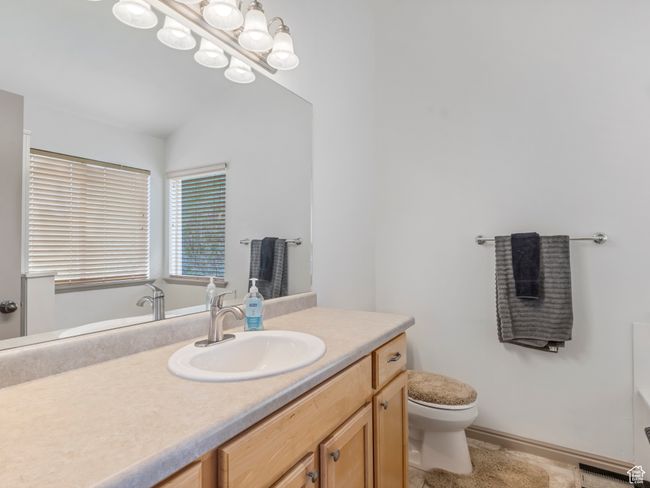 Bathroom featuring toilet and vanity | Image 18
