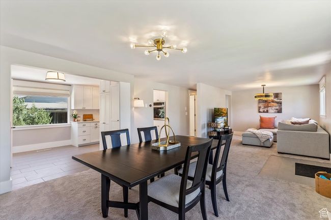 Dining room featuring a chandelier and light carpet | Image 12