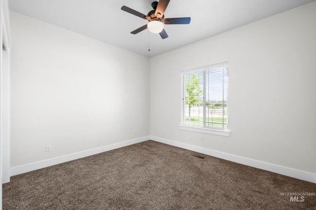 Empty room with dark carpet and a ceiling fan | Image 29
