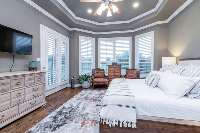 Bedroom featuring multiple windows, recessed lighting with overhead fan, crown molding, and access to exterior | Image 18