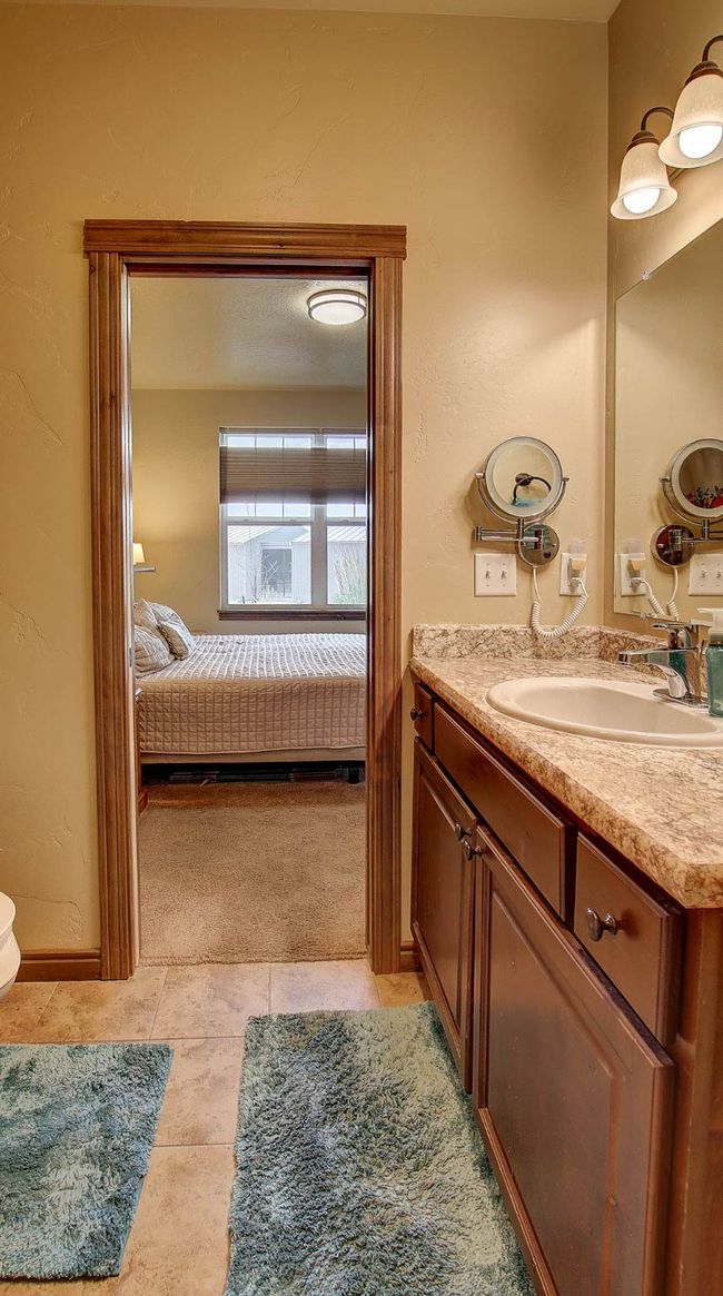 Primary Bathroom offers walk-in shower, extra storage cabinets and electric wall heater | Image 24