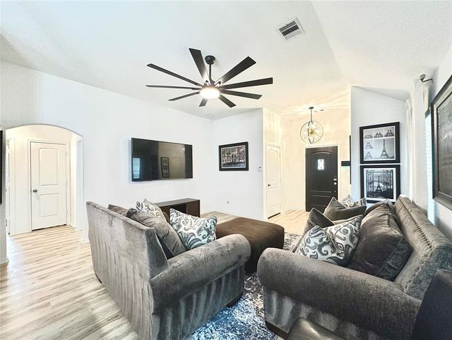 Another view of the living room with spacious foyer, upgraded fixtures and elegant design such as archway to the bedrooms. | Image 5