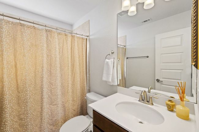 Bathroom featuring visible vents, toilet, and vanity | Image 24
