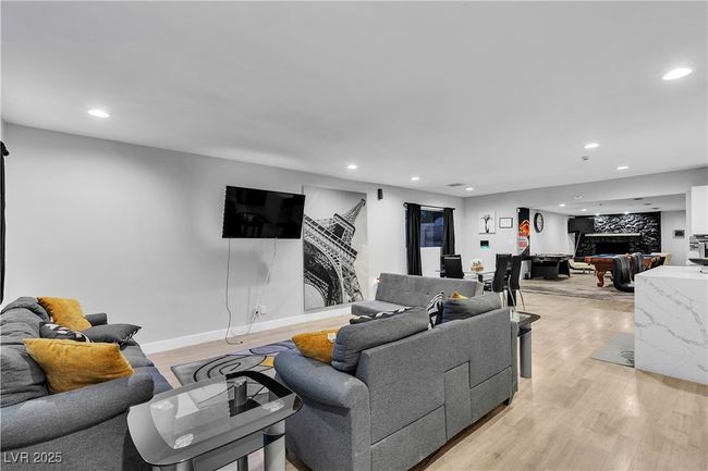 Living room featuring a fireplace, recessed lighting, light wood-style flooring, and baseboards | Image 5