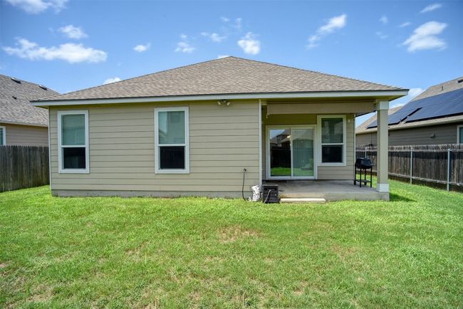 Back of house with a patio area, a fenced backyard, and a shingled roof | Image 31